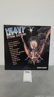 Front cover of the Heavy Metal double LP album vinyl record featuring a fantasy creature and artist list.