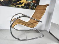 Overall left side profile showing cantilever frame and woven rattan seat