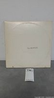 Front of the white gatefold vinyl cover with 'The BEATLES' text centered.