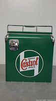 Front view of green and white Wakefield Castrol motor oil cooler with bottle opener on front left side and metal handle on top.