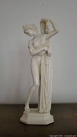 Statue of Aphrodite front view showing draped gown and elegant pose.
