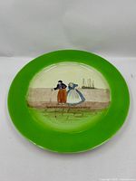 Front view showing full plate, green rim and central Dutch scene