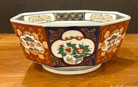 Side view of octagonal bowl showing painted panels and colors