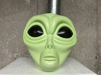 Front view of lime green plastic alien head