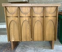 Closed front view showing arched panel design and overall condition.