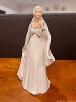 Front view of Royal Doulton Bride figurine showing gown and bouquet