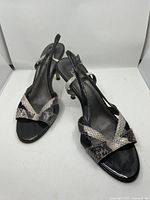 Front angled view of both shoes showing strappy design and materials