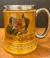 Front view showing illustration, rhyme, handle, metallic rim and floral band