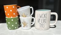 Five mugs: two Federal milk glass Canada Goose, two polka-dot, one Rae Dunn