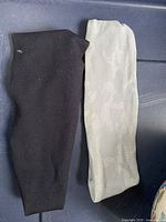 Two headbands side by side: grey camo Lululemon and plain black unknown brand.
