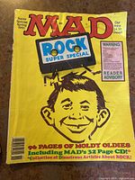 Front yellow cover of the MAD Magazine Rock Super Special Spring 1991 issue featuring Alfred E. Neuman with a TV screen and the title in bold red and blue.