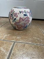 Full round view of the vase showing the floral pattern and colors.
