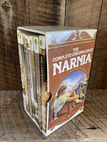 Picture of the right side of the box set showing the boxed spine and part of the front cover illustration of a boy looking out with a castle and landscape in the background.