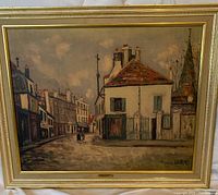 Front view of framed print depicting a street scene by Maurice Utrillo titled "Small Hostelry"