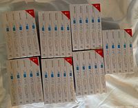 Full view of 35 unopened Memorex VHS videotape boxes arranged on a surface, showing quantity and packaging condition.