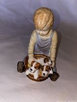Front view of Paragon bone china figurine showing boy with puppies in basket
