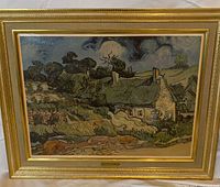 Full view of the framed print artwork depicting thatched cottages with vibrant signature-style brush strokes inside an ornate gold frame.