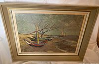 Full view of framed artwork print showing fishing boats on beach with muted earth-tone colors and textured brush stroke style.