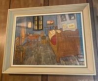 Full view of the framed Vincent Van Gogh print "The Bedroom at Arles" showing the artwork and entire off-white wooden frame.