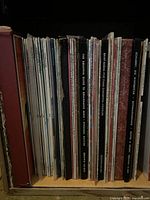 Side view of a collection of vinyl records showcasing their album spines, mostly classical music genres.