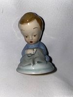 Front view of the Wade ceramic 'Tailor' figurine showing the detailed face and sewing pose.