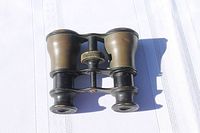 Top view of antique Lemaire Paris opera glasses showing overall condition and focus knob.