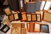 Overview of all photo frames spread out on white surface, showing variety of styles and sizes