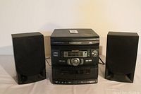 Front view of Sharp CD-C1800 mini component stereo system with left and right speakers showing control panel, cassette decks, and CD changer drawer