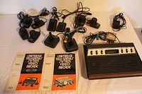 View of main console, controllers, and owner's manuals showing lot contents