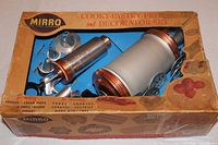 Vintage Mirro Cook-Pastry Press and Decorator Set visible inside original box with copper accent metal parts and multiple decorative plates and tips.