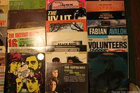 Wide view showing the front covers of various vinyl LP records in the collection with visible wear on covers.