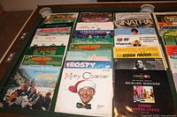 Multiple LP albums laid out on a table showing titles including Christmas albums, Sinatra, The Beach Boys, and others.