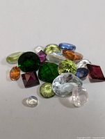 Close-up photo of assorted loose gemstones showing colors and shapes