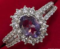 Close-up front view of the silver ring with purple amethyst and clear cubic zirconia stones showing details of stones and split band