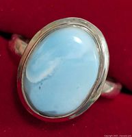 Close-up image of the silver ring with oval turquoise stone showing the color and texture of the stone and silver setting.