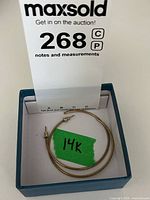 Pair of medium-large 14k yellow gold hollow hoop earrings, each with post and butterfly backing, shown in box with 14k label.