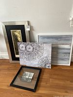 All five framed art pieces arranged on floor against wall showing sizes and detail