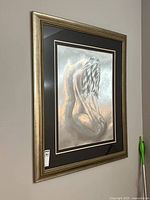 Front view of the framed print showing the full image of the kneeling woman and detailed frame.