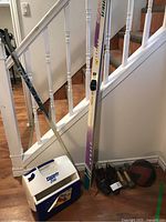 Peltonen vintage skis with bindings, Excel ski poles, Igloo Playmate Elite cooler, wooden dumbbells, and medicine ball