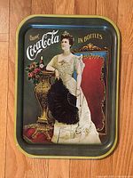 Front view of rectangular metal Coca-Cola tray with anniversary artwork and text.