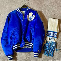 Full view of jacket and scarf laid flat on floor