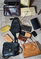 Overview of all eleven items arranged on floor showing variety of purses and wallets