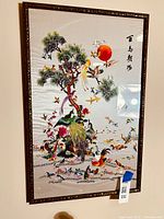 Full view of the framed Chinese silk embroidery tapestry showing the full artwork including the hundred birds, pine tree, red sun and calligraphy.