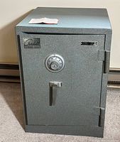 Front exterior view of gray crinkle finish safe showing combination dial and handle