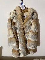 Full front view of coat hanging on wall