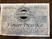 Close-up photo of Armstrong & Blackbury Flower Press Kit label showing product details and usage instructions.