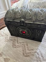 Closed boombox shaped like a treasure chest with detailed pirate-themed embossed metal design.