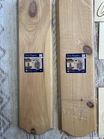 Two pine wood plaques, still shrink-wrapped, with visible Demis Pine Plaques labels.
