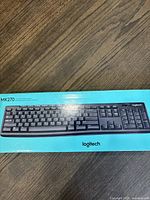 Box of Logitech MK270 full-size wireless keyboard showing top view of the keyboard keys.