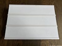 Top view of a white rectangular light box with three horizontal sections for inserting letters or symbols.